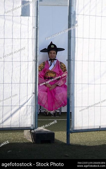 14 May 2022, Hessen, Frankfurt/Main: A member of Hanbok Fashion Show, which shows traditional clothes from Korea during the K-Pop mega-festival ""KPOP