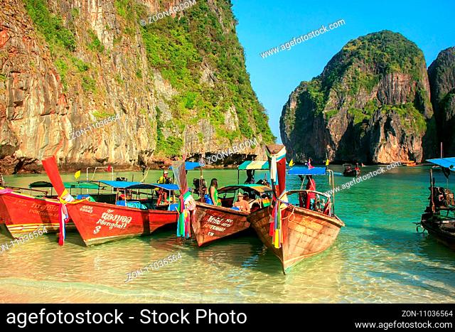 Longtail boats anchored at Maya Bay on Phi Phi Leh Island, Krabi Province, Thailand. It is part of Mu Ko Phi Phi National Park