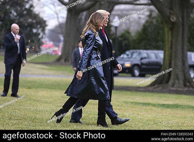 United States President Donald J. Trump and first lady Melania Trump walk on the South Lawn of the White House before boarding Marine One on January 13