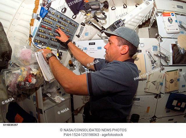 FILE: In this photo released by NASA, Astronaut William A. (Bill) Oefelein, STS-116 pilot, works at a control panel on the middeck of Space Shuttle Discovery...
