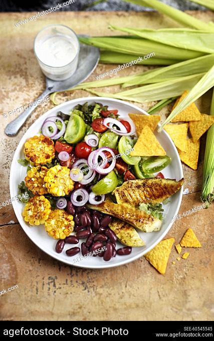 Mexican salad with chicken, corn, tomatoes, onions and red beans