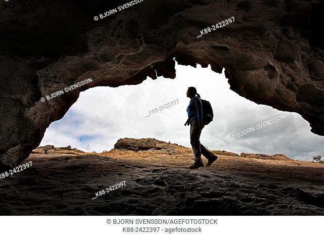 Hiker outside cave in the northern Grampians. Victoria, Australia