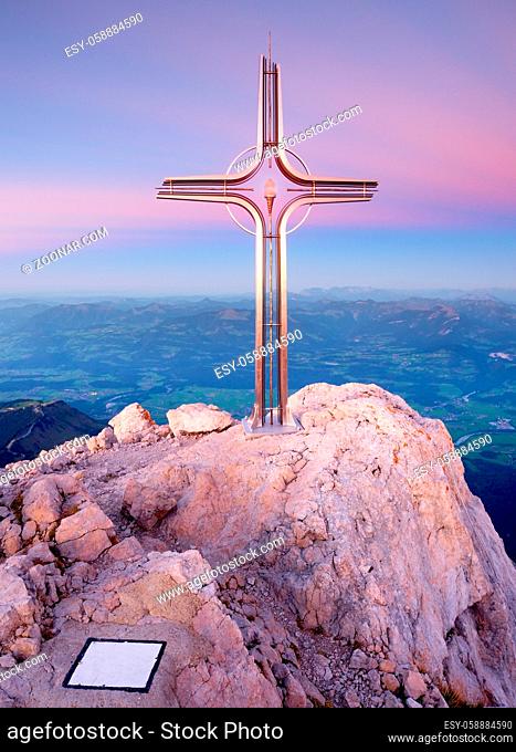 Peak of Hoher Goell. Iron cross at mountain top in Alp at Austria Germany border. View to Tennen Range and Dachstein range, Berchtesgaden Alps