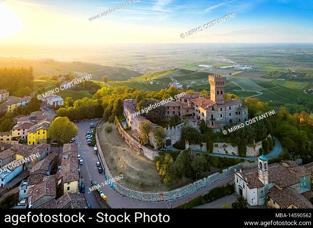 Aerial view of the Cigognola castle and vineyards at sunset. Cigognola, Oltrepo Pavese, Province of Pavia, Lombardy, Italy