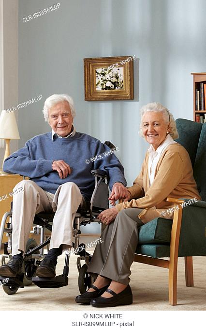 Senior couple, man in wheelchair, portrait