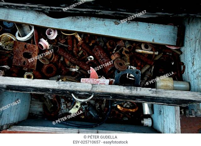 Rusty metal tools in an abandoned drawer