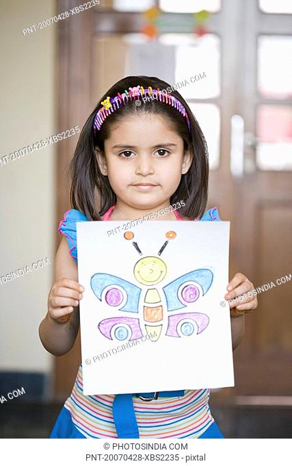 Portrait of a girl showing her drawing