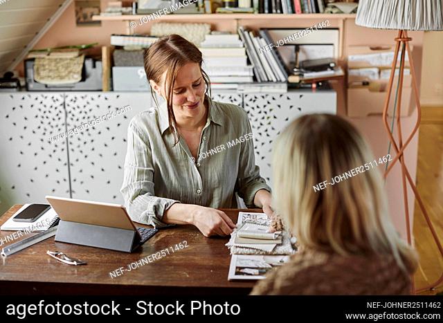 Women sitting at desk and looking at samples