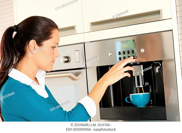 Happy woman making coffee machine kitchen cup