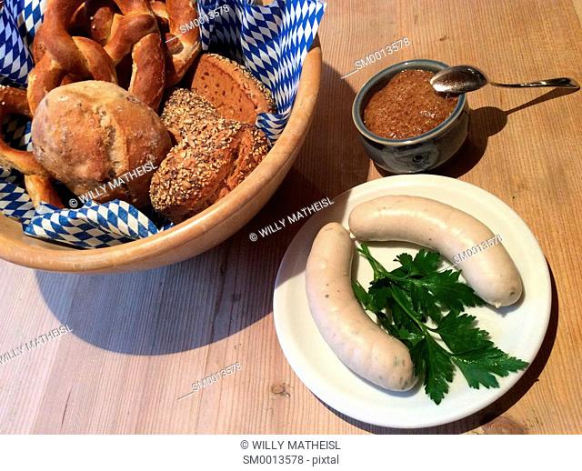 Weisswurst and pretzel for a traditional breakfast to be served and eaten before 10 o`clock in Bavaria, Germany, Europe