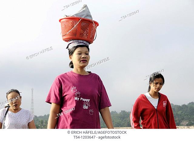 Burmese Woman walk with a Basket on the Head in Sanglaburi