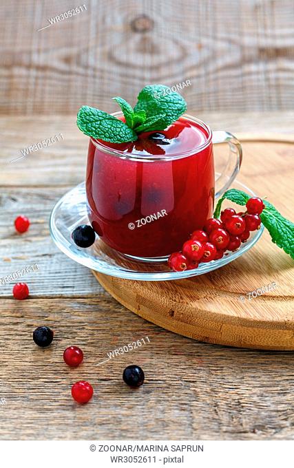 Kissel of red and black currants with sprig of mint