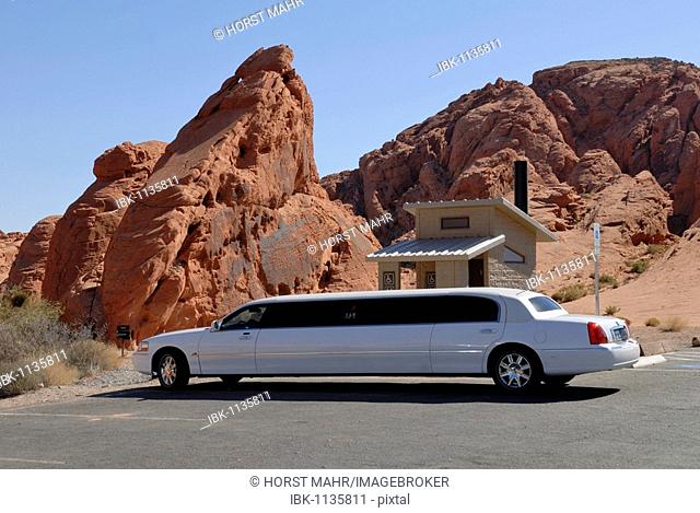 Luxury car in front of a toilet hut, Rainbow Vista, Valley of Fire State Park, Nevada, USA
