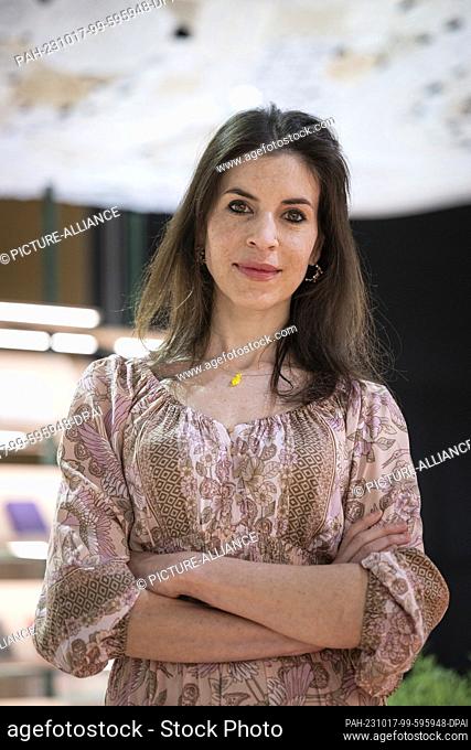 17 October 2023, Hesse, Frankfurt/Main: Eva Petric, artist from Slovenia, stands in front of her honeycomb installations in the pavilion of the guest of honor...