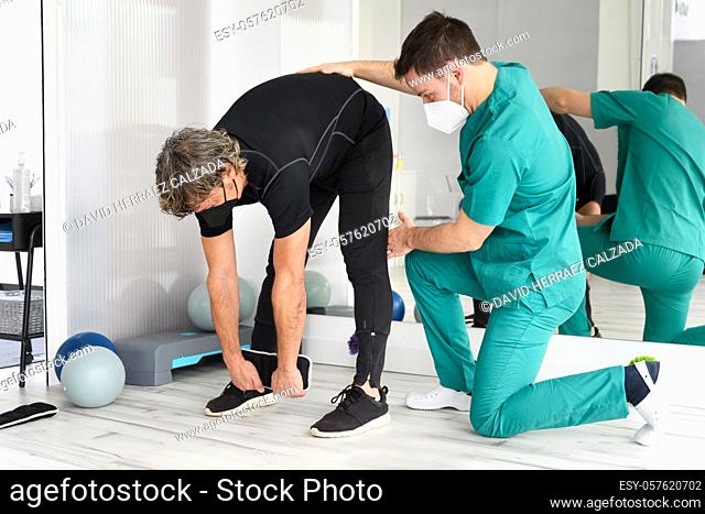 Physiotherapist helping patient in clinic. High quality photo