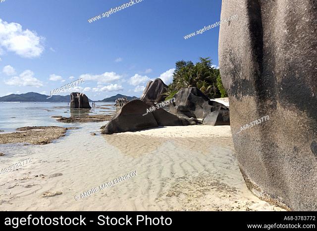 Some rocks on Anse Source D'Argent beach on La Digue island. Seychelles. Low tide. Many peaces of dead corals are littered on the sandy beach