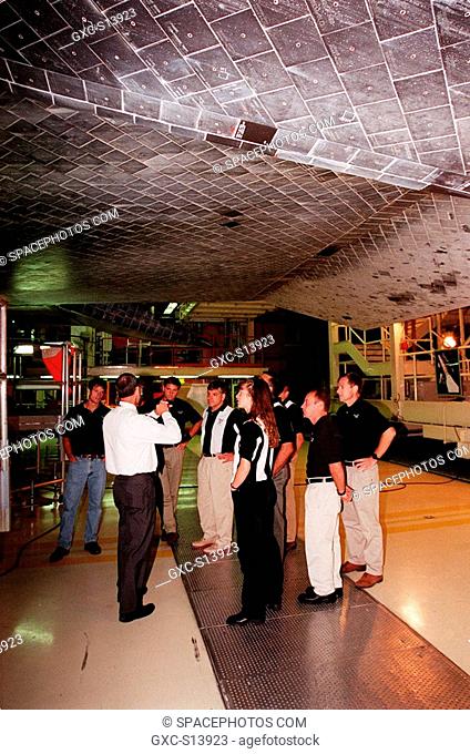 09/28/1999 --- In the Orbiter Processing Facility, members of the 1998 astronaut candidate class group 17 learn about the thermal protection system on the...