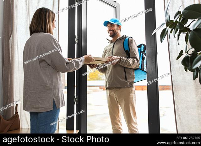 food delivery man giving order to female customer