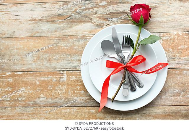 red rose flower on set of dishes