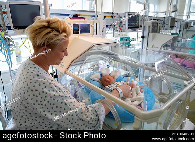 Twin mother with one of her children in an incubator, intensive care unit for newborns, Karlovy Vary, Czech Republic