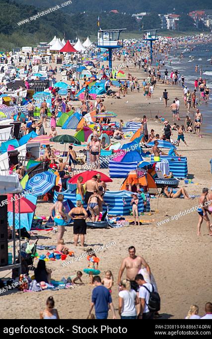 19 August 2023, Mecklenburg-Western Pomerania, Heringsdorf: Hundreds of tourists seek cooling at the Baltic Sea on the island of Usedom