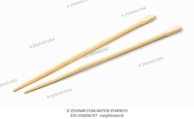 Pair of bamboo disposable chopsticks isolated on white