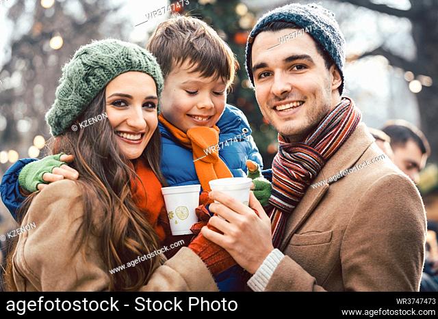Family enjoying food and drink at Christmas market