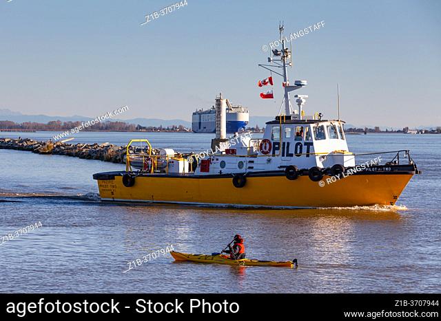 Canadian Pilot Boat heading out to meet a large car transport ship departing the Fraser River near Vancouver Canada