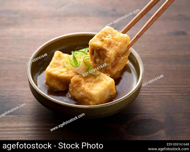 Deep-fried tofu on a wooden table. Food in Japan