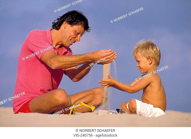 portrait, beach-scene, father sits with his son, 4 years, at the beach playing with sand  - 0, GERMANY, 22/10/2002