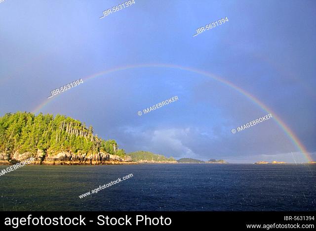Rainbow over coastline and temperate coastal rainforest, Calvert Island, Hakai Pass, Coast Mountains, Great Bear Rainforest, British Columbia, Canada