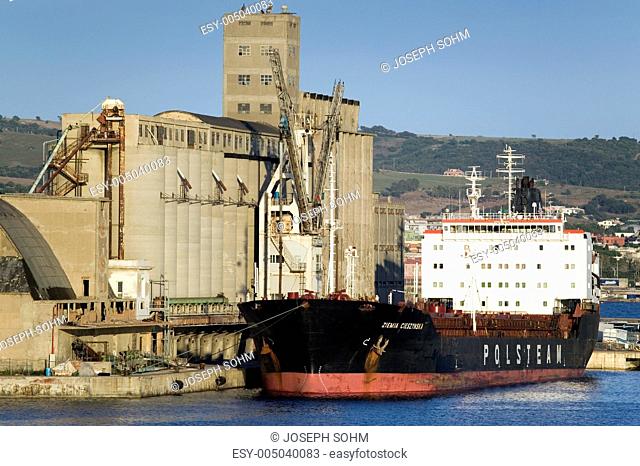 Grain silos and cargo ship at Port of Civitavecchia, Italy, the Port of Rome