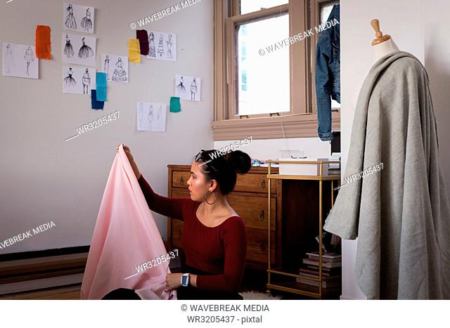 Fashion designer checking fabric