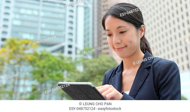 Business woman work on tablet computer at outdoor