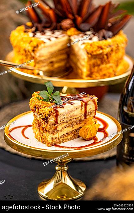 Slice of cake with crushed nuts and caramel topping