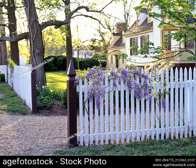 Exterior of country style house with white picket fence