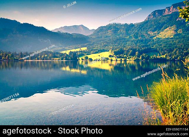 Sunny morning landscape on Grundlsee lake. Beautiful summer view of Gessl village, Liezen District of Styria, Austria, Alps. Europe
