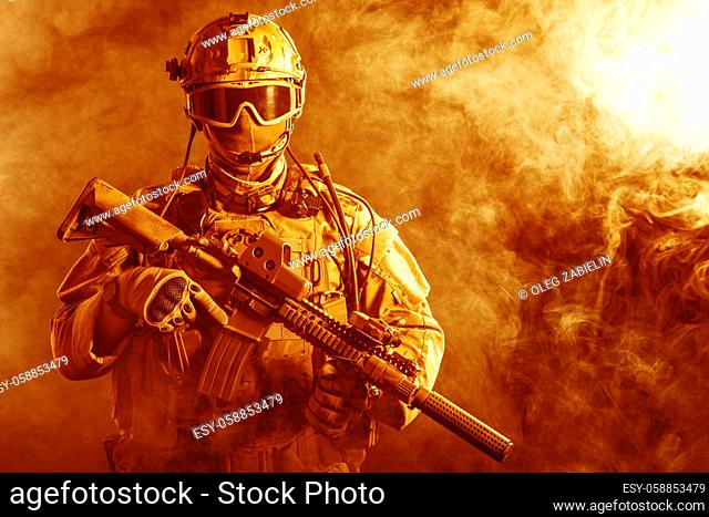 Special forces soldier with rifle in the fire