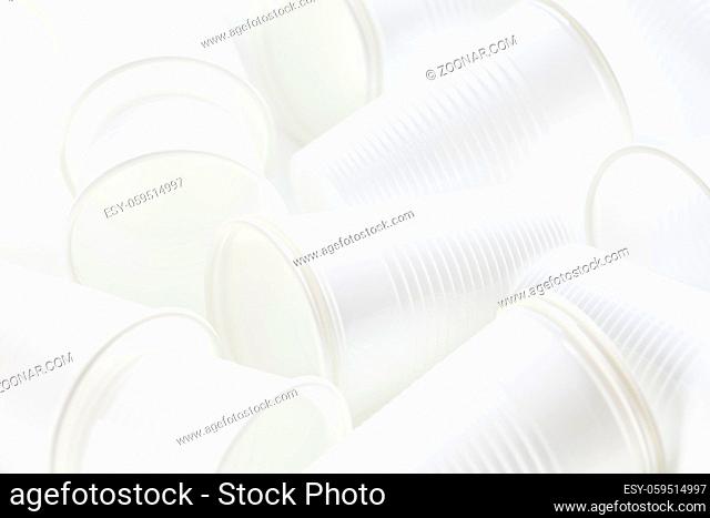 Disposable white plastic cups as background. Environmental concept. Non-compostable waste