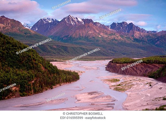 A riverbed flows by a beautiful mountain range