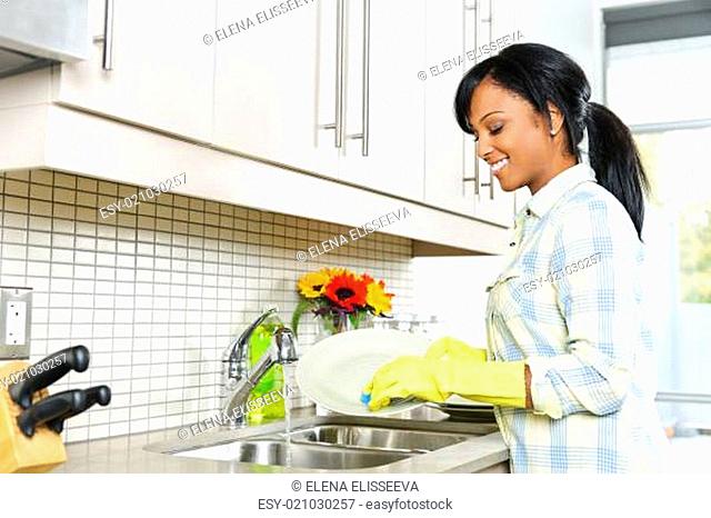 Young woman washing dishes