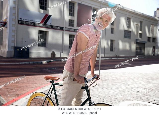 Mature man riding bicycle in the city