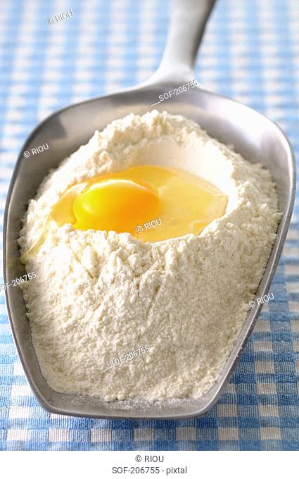 Scoopful of flour and a broken egg