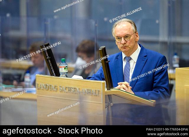 04 March 2021, Saxony-Anhalt, Magdeburg: Reiner Haseloff (CDU), Minister President of Saxony-Anhalt, stands at the lectern in the plenary hall of the state...