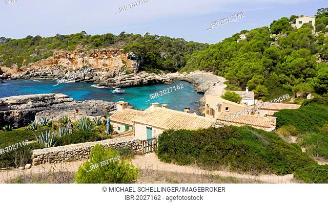 Rocky coastline with fishermen's houses near Cala s'Almunia, Majorca, Spain, Europe