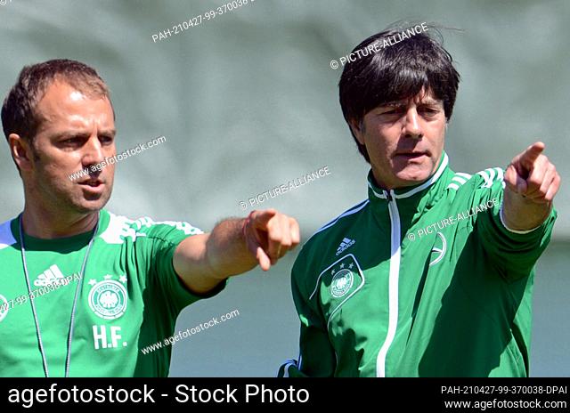 FILED - 19 June 2012, Poland, Danzig: German coach Joachim Löw (r) and his then assistant coach Hans-Dieter ""Hansi"" Flick gesture during a training session of...