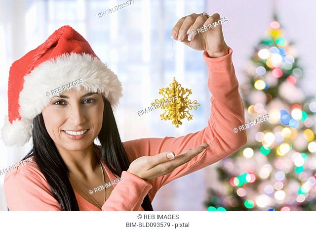 Turkish woman holding up Christmas ornament