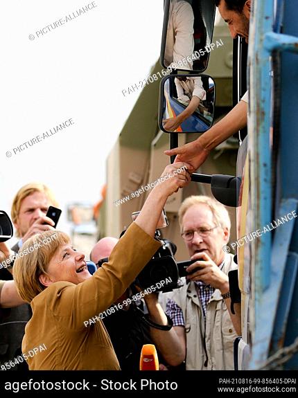 dpatop - FILED - 10 May 2013, Afghanistan, Kundus: German Chancellor Angela Merkel (l, CDU) visits Bundeswehr soldiers in the field camp in Kunduz