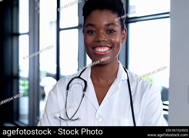 Mixed race female doctor standing looking at the camera and smiling
