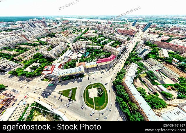 Aerial city view with crossroads and roads, houses, buildings, parks and parking lots, bridges. Helicopter drone shot. Wide Panoramic image